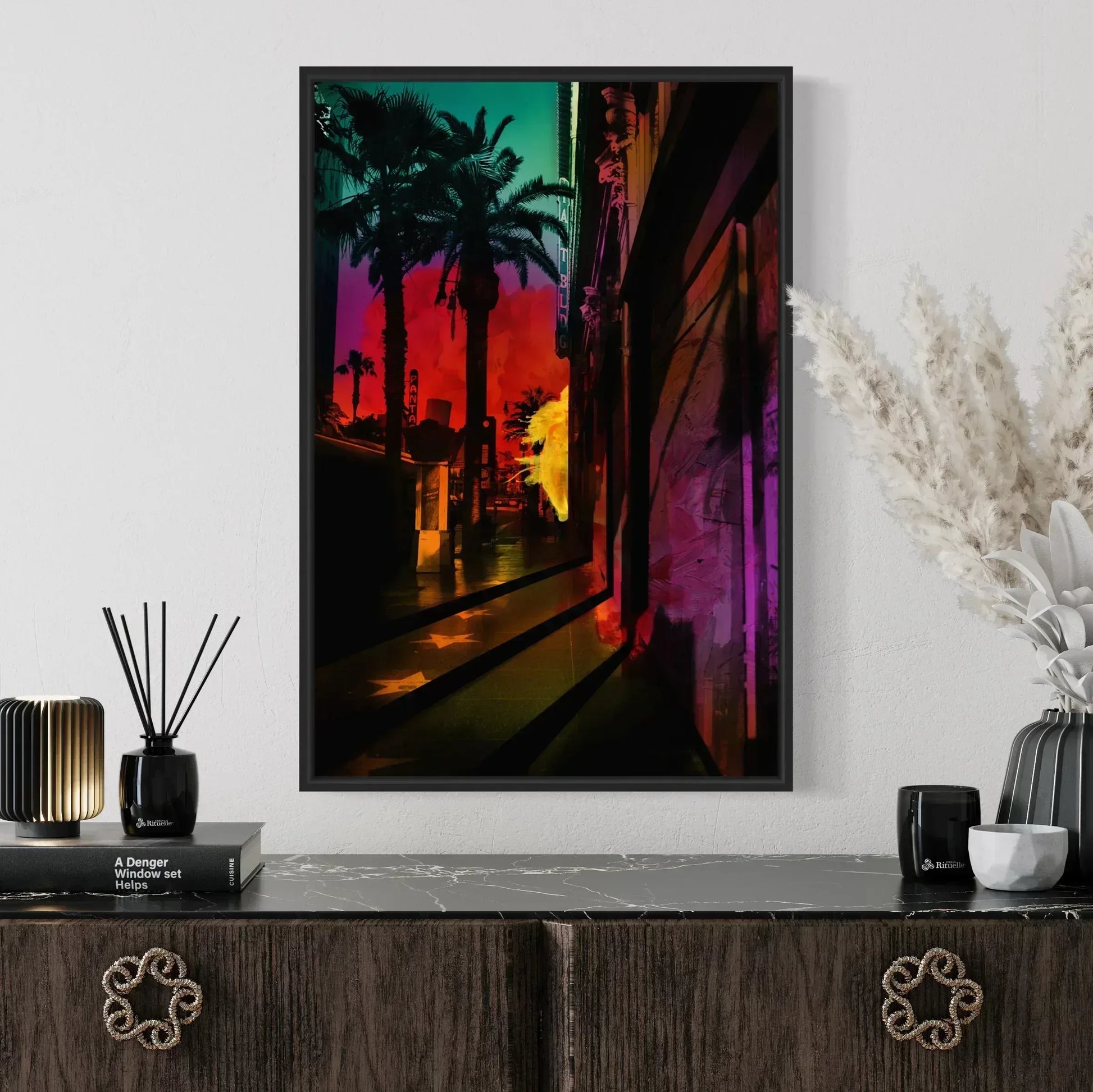 Colorful abstract painting of palm trees on a white wall above a wooden console table.