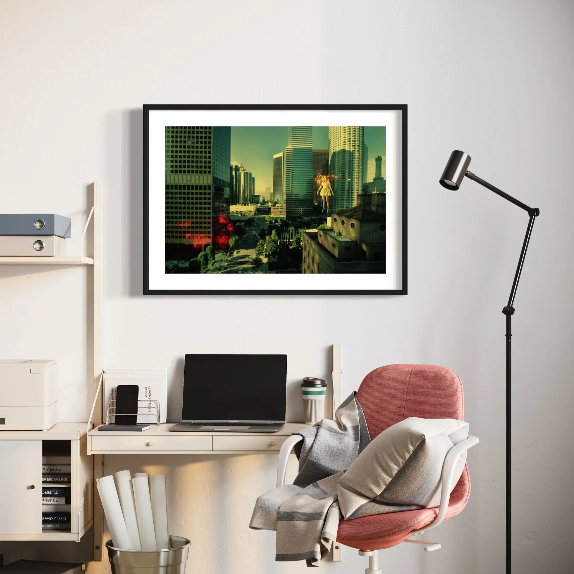 Modern office setup with a framed cityscape print, desk, chair, and lamp.