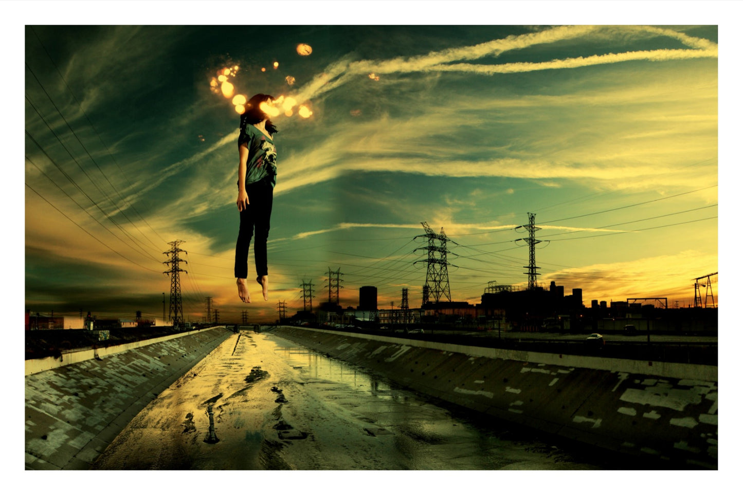 Surreal fine art photography of a person suspended over the Los Angeles River, industrial concrete landscape, acid-green and amber lighting, cinematic dreamscape.