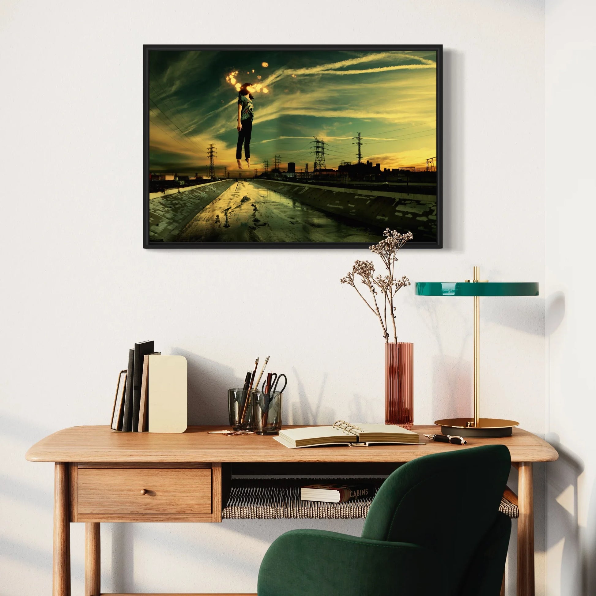 Modern office setup with a wooden desk, chair, and framed artwork on the wall.
